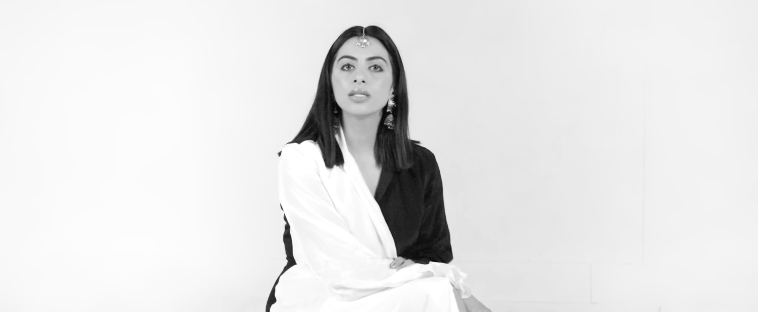 Black-and-white studio portrait of Ranjani seated in black-and-white silk