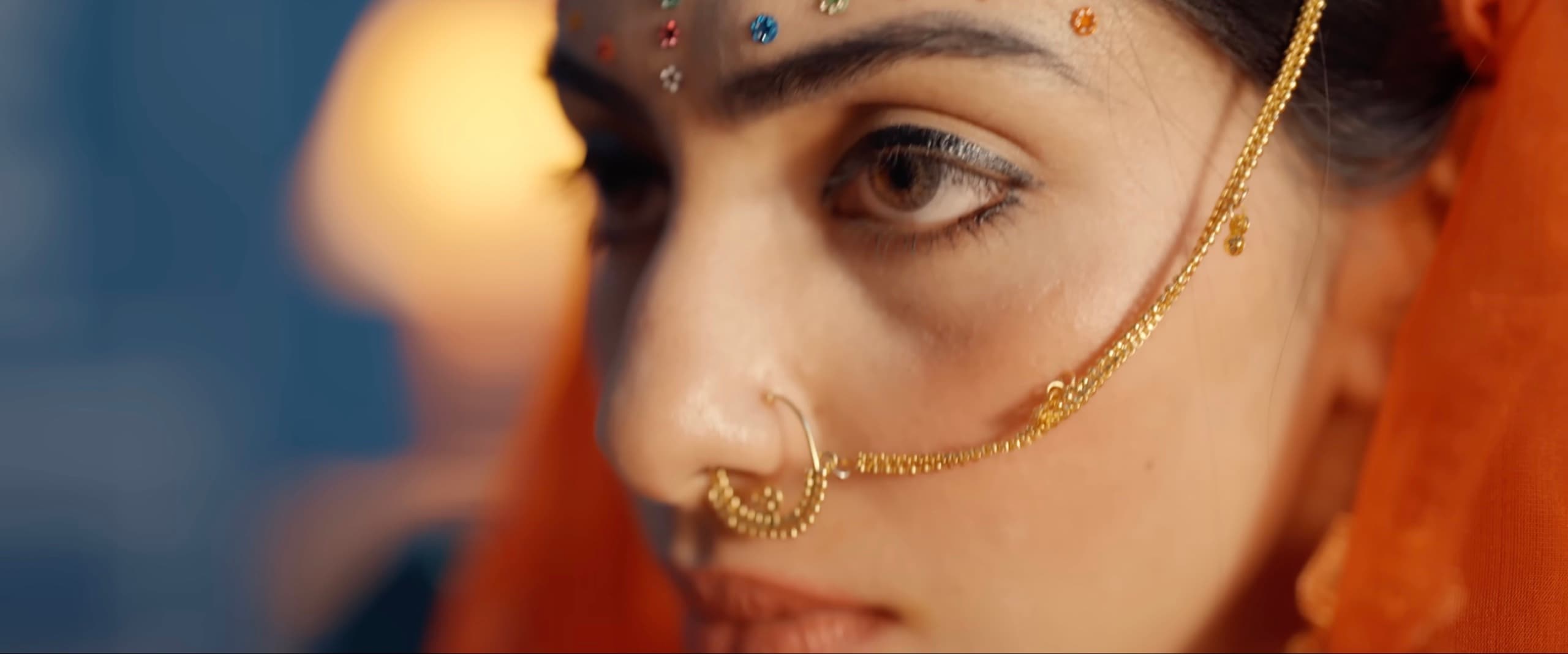 Macro detail of a gold nath nose ring and chain