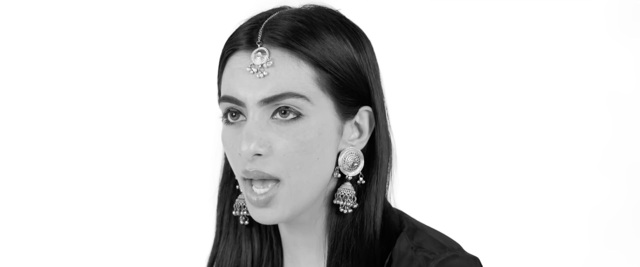 Black-and-white studio portrait of Ranjani wearing a maang tikka and jhumka earrings